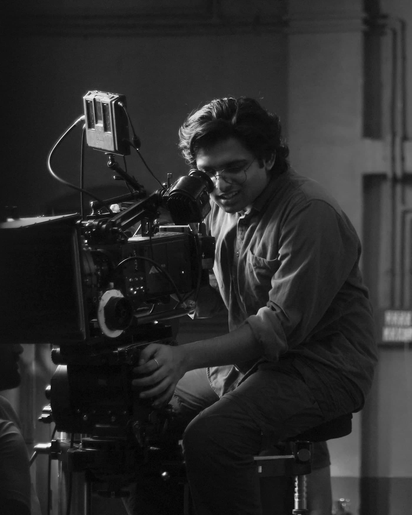 Aslam Seju operating a camera on set